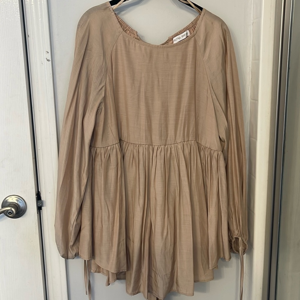 Nude top. Romantic and Flowy. Dressy. Shinier material.